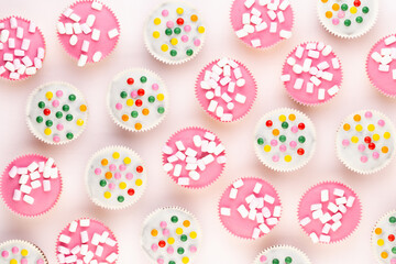 Colorful cupcakes on a white background.