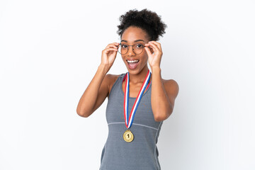 Young African American woman with medals isolated on white background with glasses and surprised