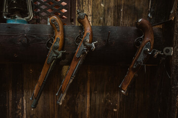 Retro, antique pistols muskets hanging on the wall