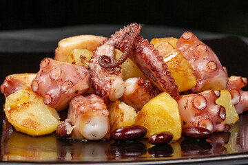 Grilled octopus with beans and fried potatoes