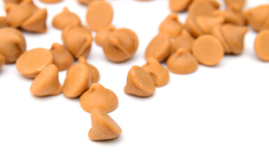 Close up pile of chocolate morsels on white background
