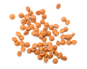 Close up pile of chocolate morsels on white background