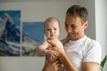 Father At Home With Newborn Baby