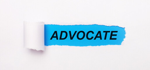 On a bright blue background, white paper with a torn stripe and the text ADVOCATE