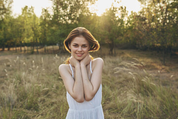 Naklejka na ściany i meble cheerful woman outdoors in a field walk fresh air summer