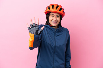 Teenager cyclist girl isolated on pink background counting five with fingers