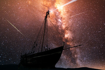 Fantasy landscape. Sailboat silhouette under bright milky way galaxy.Beautiful starry night.