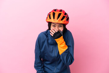 Teenager cyclist girl isolated on pink background happy and smiling covering mouth with hand - obrazy, fototapety, plakaty