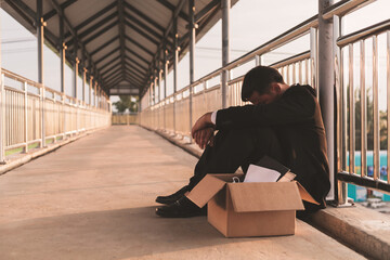 Sad Asian businessman losing job