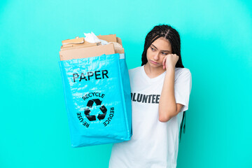 Teenager girl with braids holding a bag to recycle with tired and bored expression