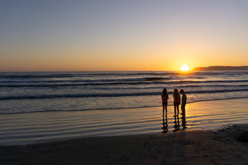 Fototapeta na wymiar Sunset conversation on the beach 