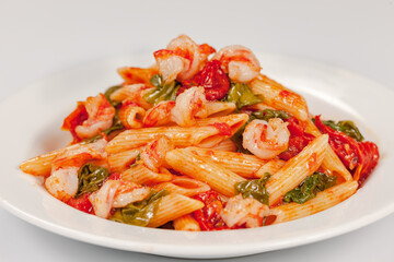 Penne pasta with shrimps, tomato sauce, parsley and grated parmesan cheese