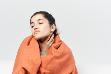 woman with a cold covered with a blanket at home treatment of infection