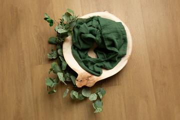 wooden tub decorated with eucalyptus. props for a photo shoot of newborns. background for a photo shoot. furniture for dolls