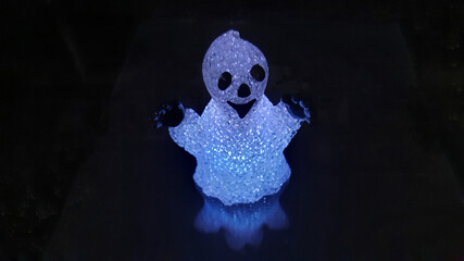 Halloween ghost isolated on black background with copy space.