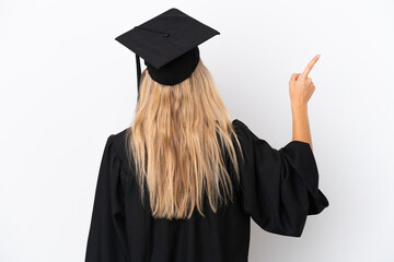 Young university graduate caucasian woman isolated on white background pointing back with the index...