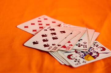 Scattered deck of cards on orange background - Powered by Adobe