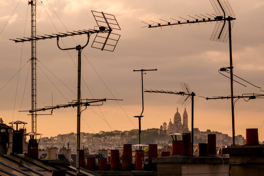 Sacr&eacute;-C&oelig;ur Basilica viewed through television aerial antennae and apartment rooftops.