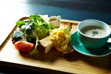 Vegetable porridge, fruit salad and bread on a wooden plate