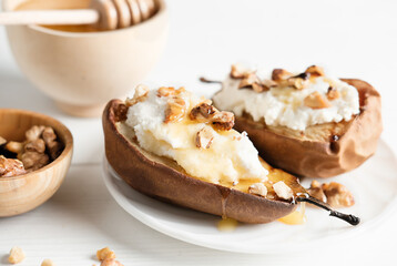 baked pear halves stuffed with ricotta and walnuts and honey topping. light dessert, low calories food for vegetarians. fall seasonal fruits.
