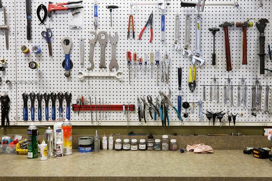 Cycle Repair Shop Interior, Tool Boards And Tools At A Service Counter.