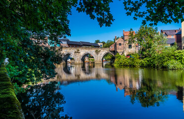 Fototapeta na wymiar A tree framed view towards the Elvet Bridge in Durham, UK in summertime