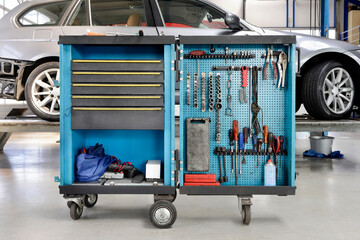 Tools on a trolley,organised in rows,at an auto repair shop.
