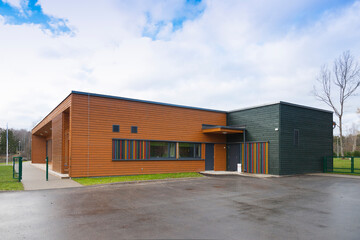 A modern building, a pre-school entrance and playground