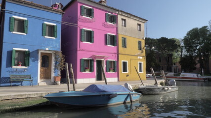 Fototapeta na wymiar Colorful facades of small houses of italian Burano on a sunny day