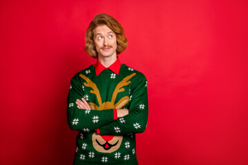 Photo of confident pretty young guy dressed print pullover smiling arms crossed looking empty space isolated red color background