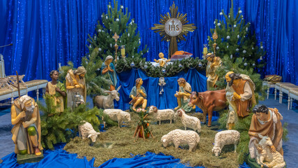 Christmas nativity scene with baby Jesus, Mary and Joseph in the manger with sheeps. Christmas event.