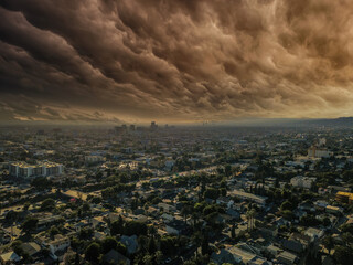 a gorgeous aerial shot of the cityscape of the city of Los Angeles with powerful clouds in the sky
