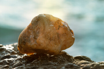 Golden stone on the background of a sea sunset