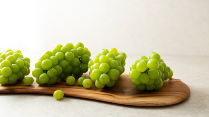 Shine Muscat, Green grapes on a large chopping board