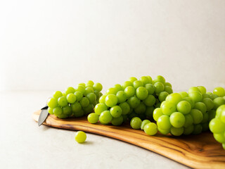 Shine Muscat, Green grapes on a large chopping board