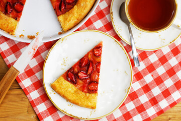 Closeup piece of gallet with strawberries and rhubarb on table. Top view.