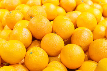 An orange pile of oranges. Fruit close-up. The concept of healthy eating