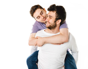 Young gay couple standing together over isolated background