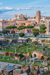 Fototapeta premium Ruins of ancient roman forum with modern and medieval city of Rome in the background