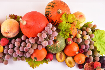 Naklejka na ściany i meble Autumn background still life of colorful fruits and flowers in the form of a gradient. Place for your text.