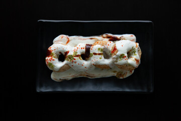 Tasty indian food item dahi vadaDahi vada or bhalla is a type of chaat originating from the Indian and popular throughout South Asia. It is prepared by soaking vadas in thick dahi or curd.