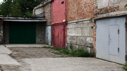 Brick garages. Garage doors. Grunge architecture.