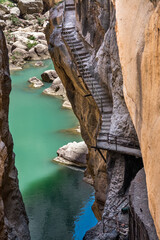 On the Caminito del Rey. An ancient staircase descends into the narrow and vertiginous canyon of the gorges of Gaitanes - 458974475