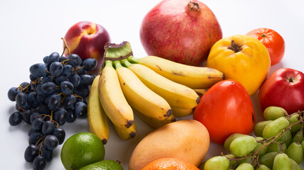 Mix of fresh juicy colorful exotic tropical fruits on white background