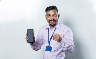 Indian man showing positive attitude with phone in hand 