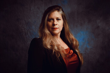 Pictorial portrait of middle-aged woman against canvas background