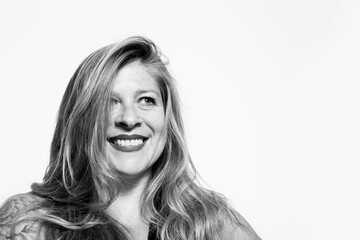 Black and white portrait of smiling middle-aged woman on white background
