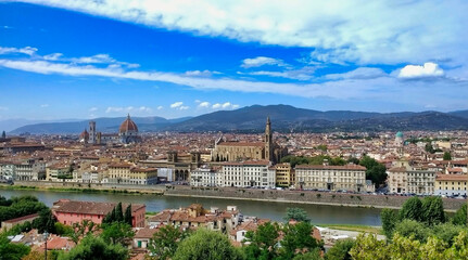 Fototapeta na wymiar Panorama of the historic part of Florence. Churches, houses, river, sky and hills. Tuscany. Italy. Europe