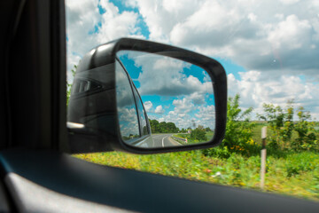 car travel concept road reflection in rear mirror view