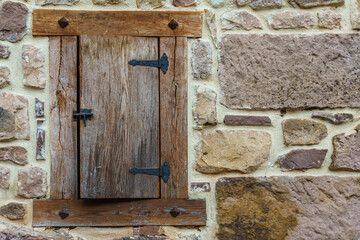 Wooden window in the wall of a typical Spanish rustic house